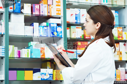 Image of Pharmacy chemist woman in drugstore