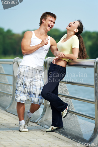 Image of Young man and woman relaxing after jogging