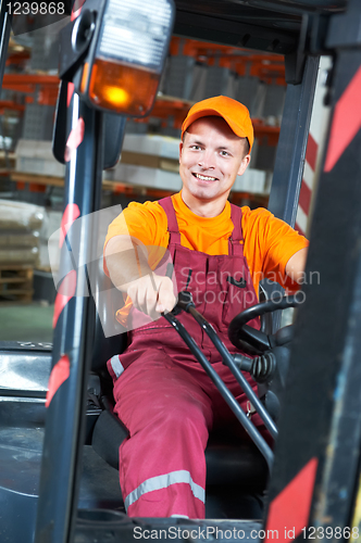 Image of warehouse worker driver in forklift