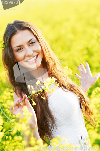 Image of girl with flowers at summer field