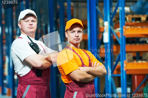 Image of young manual workers in warehouse