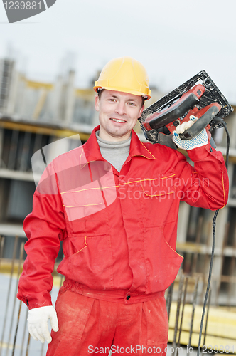 Image of portrait of construction worker with saw
