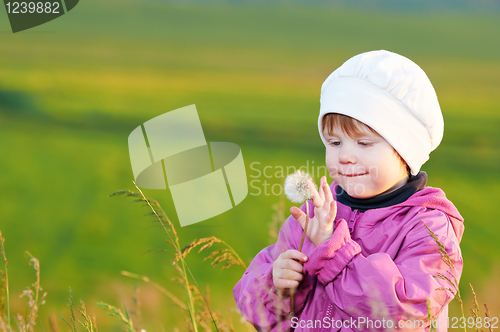 Image of baby with dandelion