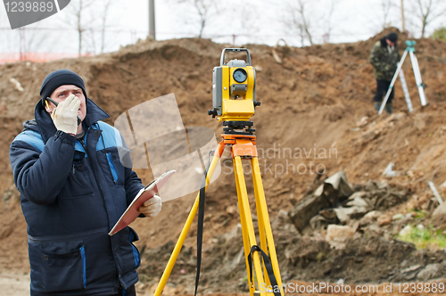 Image of surveyor works with theodolite tacheometer