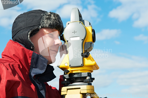 Image of surveyor works with theodolite tacheometer