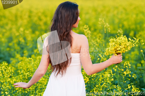 Image of girl with flowers at summer field