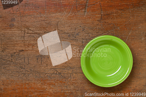 Image of green bowl on grunge wood