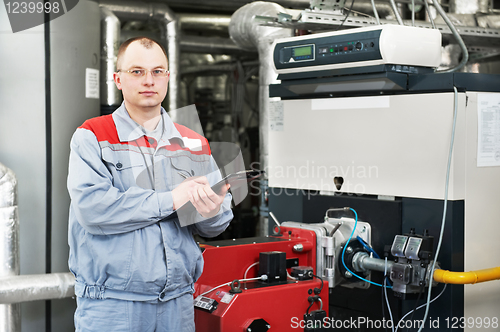 Image of heating engineer in boiler room