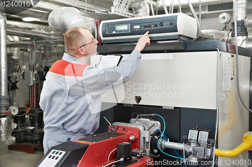 Image of heating engineer in boiler room