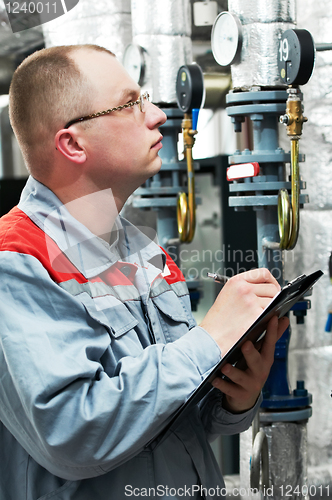 Image of heating engineer in boiler room