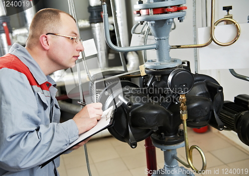 Image of heating engineer in boiler room