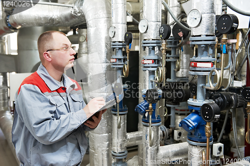 Image of heating engineer in boiler room