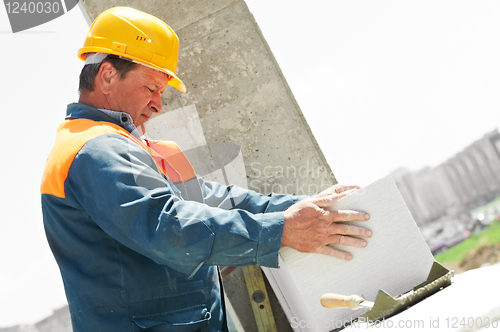 Image of bricklayer at construction masonry works