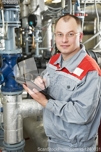 Image of heating engineer in boiler room