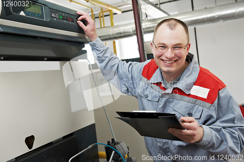 Image of heating engineer in boiler room