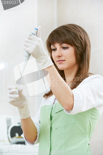 Image of female doctor with dropper