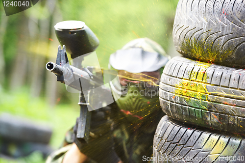 Image of paintball player under gunfire