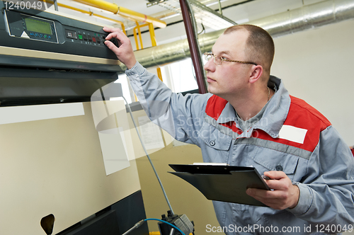 Image of heating engineer in boiler room