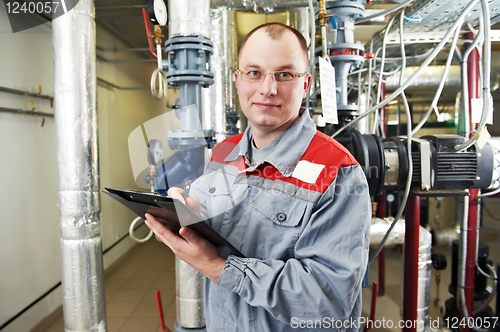 Image of heating engineer in boiler room