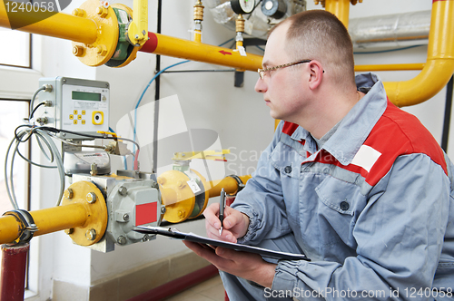 Image of heating engineer in boiler room