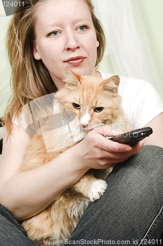 Image of girl watching tv with cat