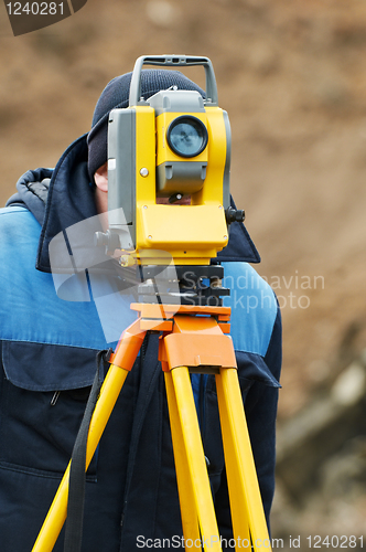 Image of surveyor works with theodolite tacheometer