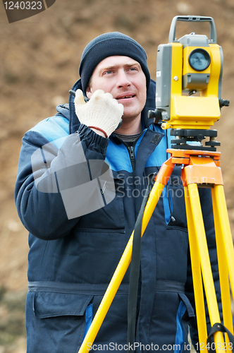 Image of surveyor works with theodolite tacheometer