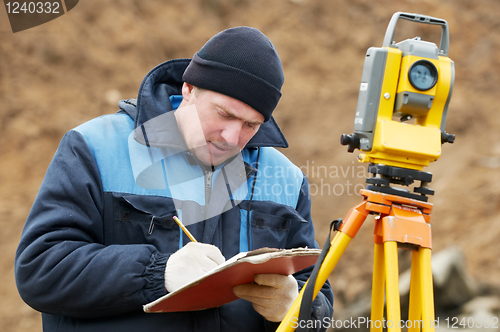 Image of surveyor works with total station tacheometer