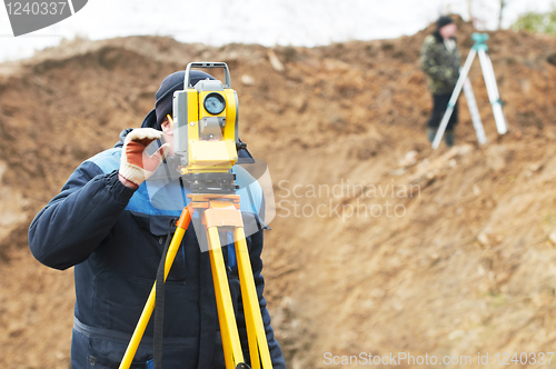Image of surveyor works with total station tacheometer