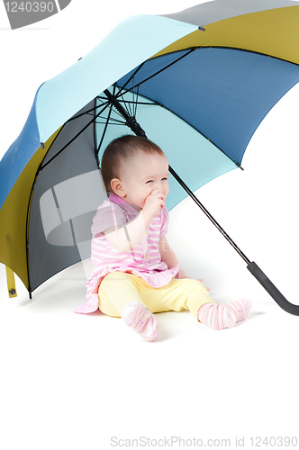 Image of Cute baby girl under umbrella