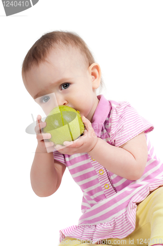 Image of Baby girl in pink eating apple