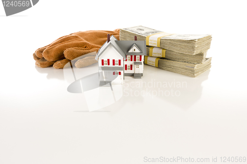 Image of Stacks of Hundreds with Work Gloves and Small House