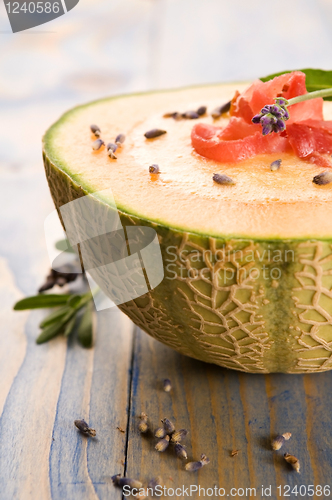 Image of fresh melon soup with parma ham and lavender flower