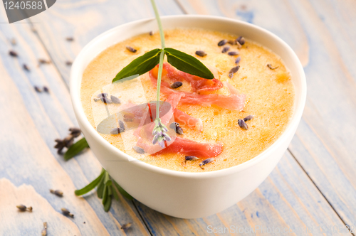 Image of fresh melon soup with parma ham and lavender flower