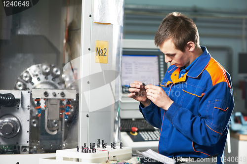 Image of worker measuring detail