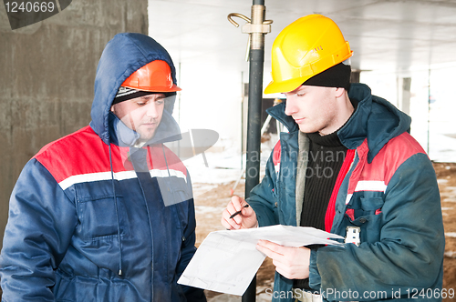 Image of Engineers builders at construction site