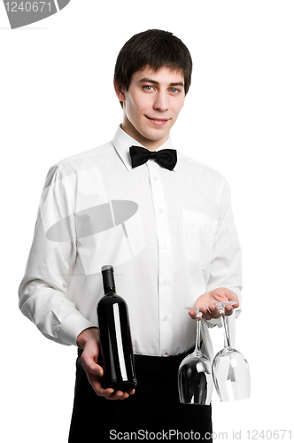 Image of Waiter sommelier with wine bottle and stemware
