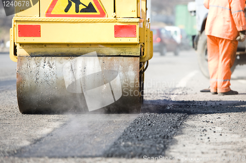 Image of Asphalt paving works with compactor