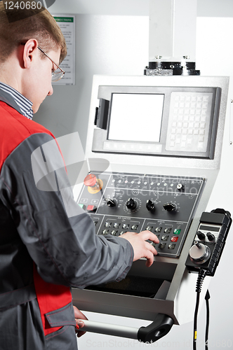 Image of worker at machining tool workshop