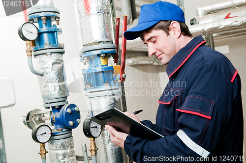 Image of heating engineer in boiler room