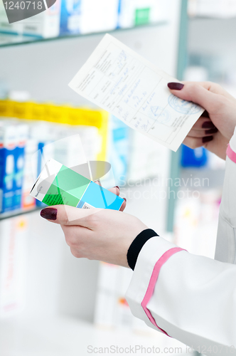 Image of closeup hand of chemist with drug