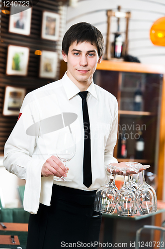 Image of waiter in uniform at restaurant