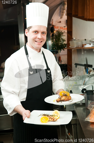 Image of chef with prepared food on plates