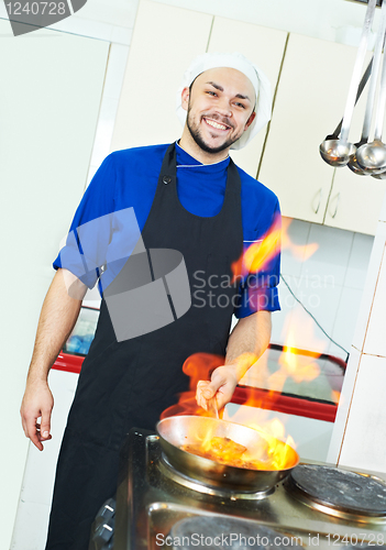Image of chef making flambe meat