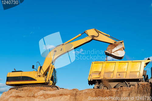 Image of excavator and dumper truck