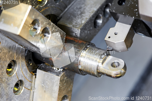 Image of Close-up process of metal machining by threading