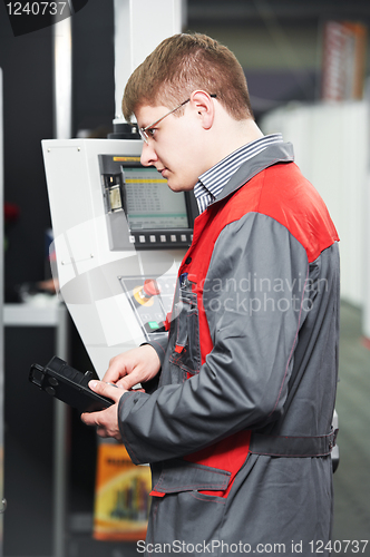 Image of worker at machining tool workshop