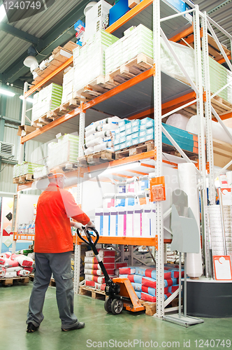 Image of worker distribution in warehouse with forklift