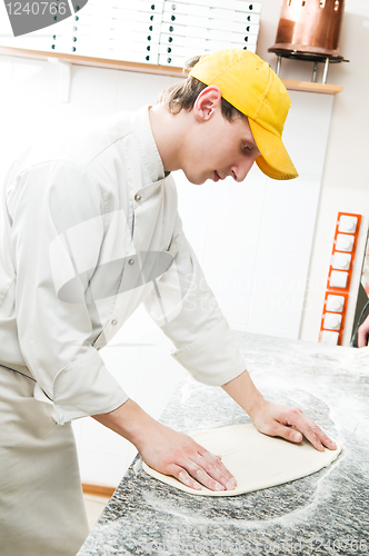 Image of baker making dough for Pizza