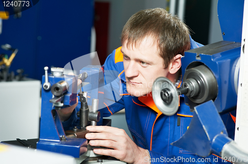 Image of worker at machine tool operating